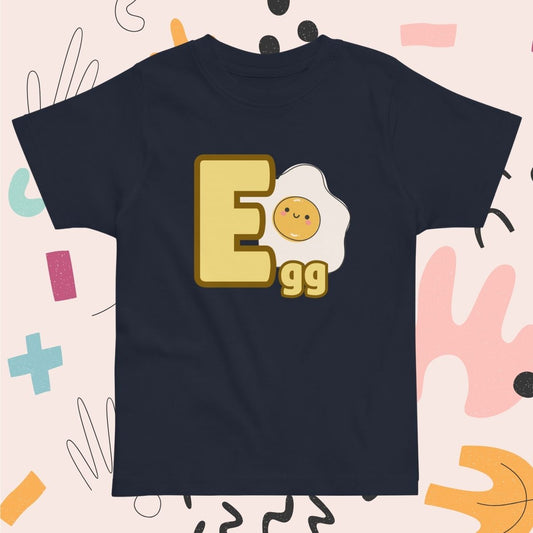 Toddler navy blue shirt designed with Egg image and text on playful pink background