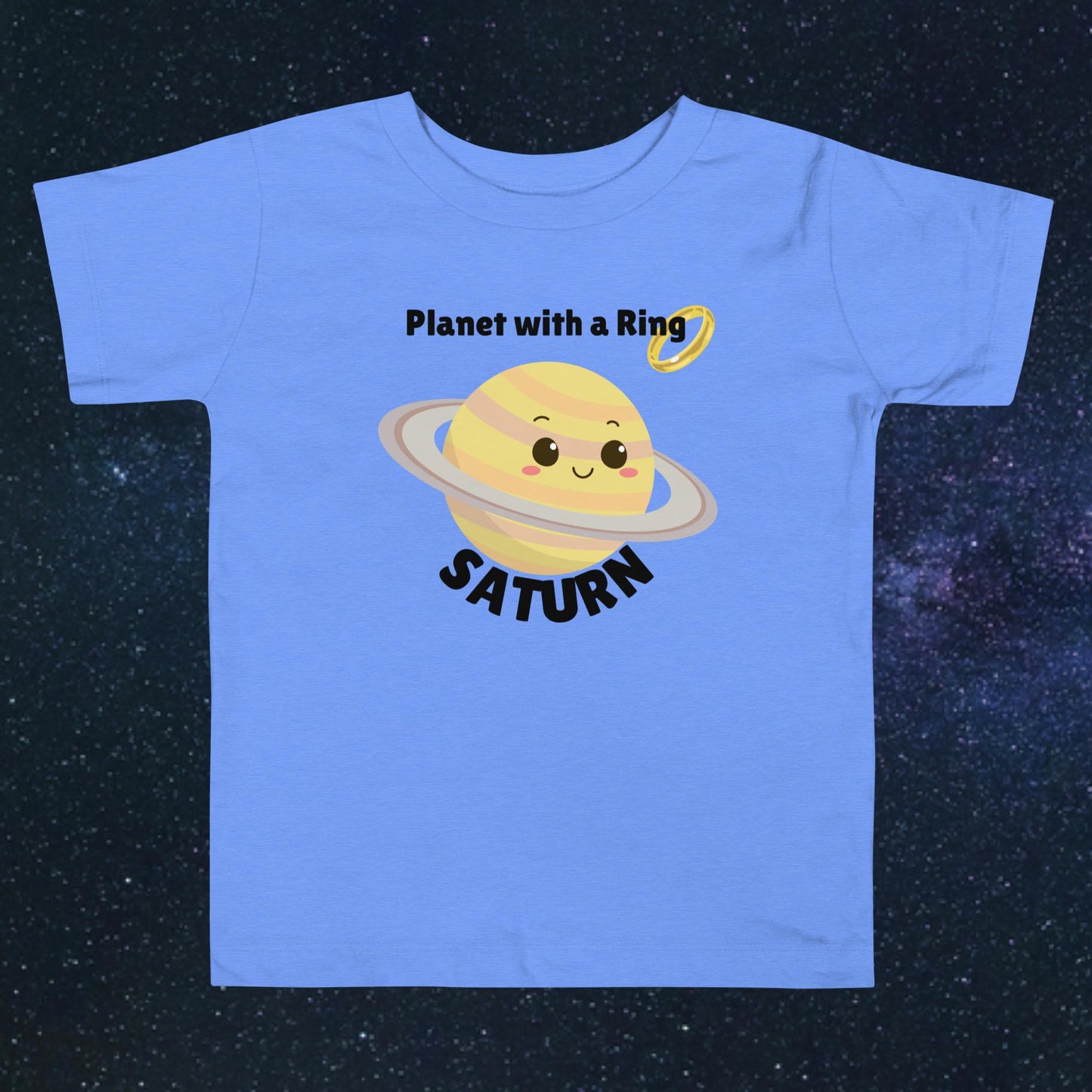 Toddler blue t-shirt with bold 'Saturn' text, Saturn graphic, and 'Planet with a Ring' subtext on a space-themed background