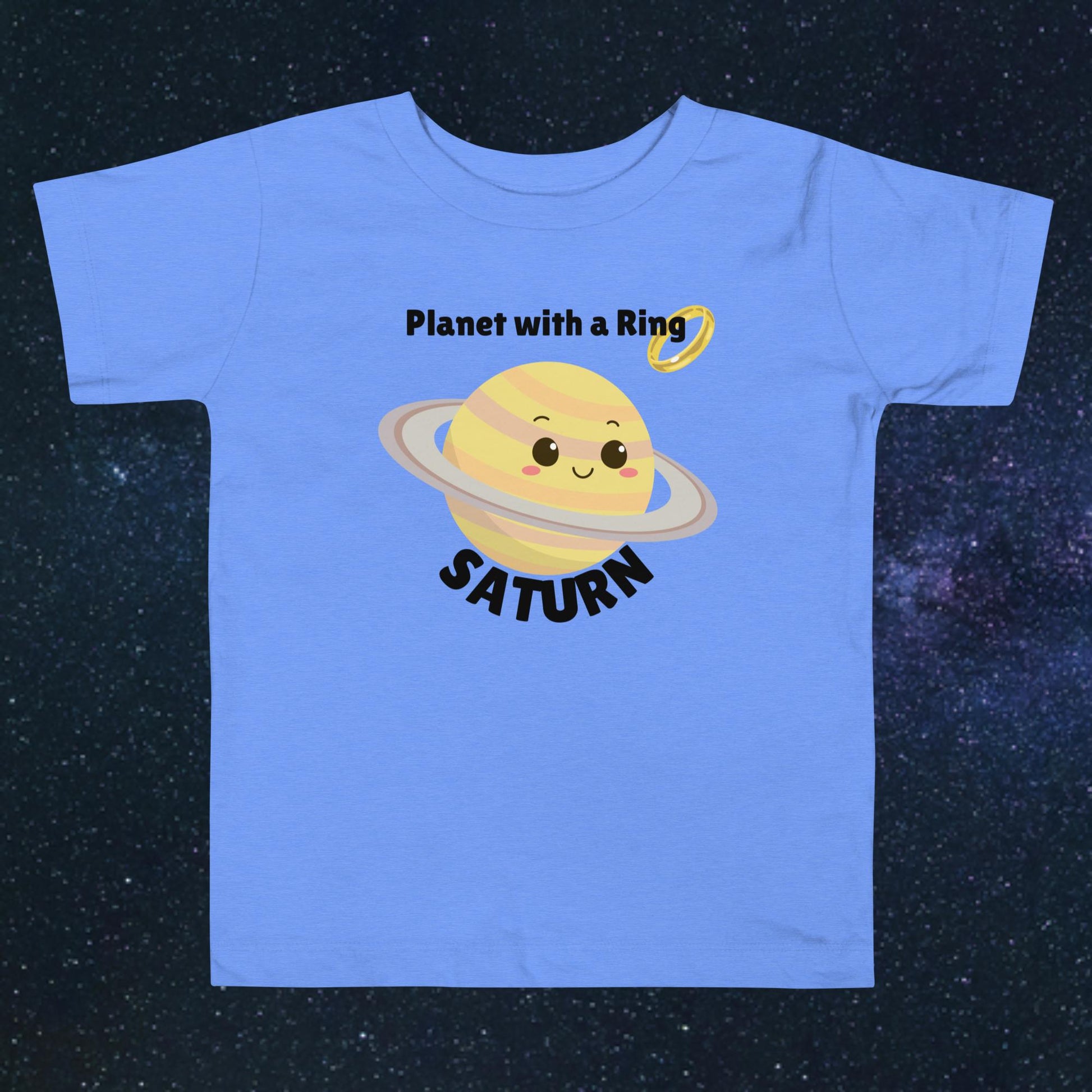 Toddler blue t-shirt with bold 'Saturn' text, Saturn graphic, and 'Planet with a Ring' subtext on a space-themed background