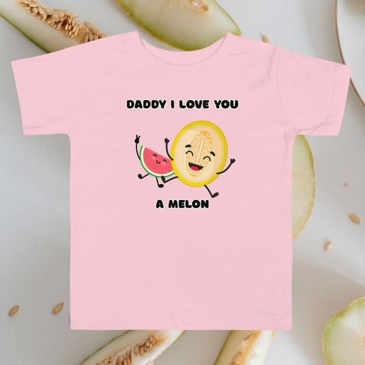 Toddler pink t-shirt with 'Daddy I Love You A Melon' statement design on background with sliced melons