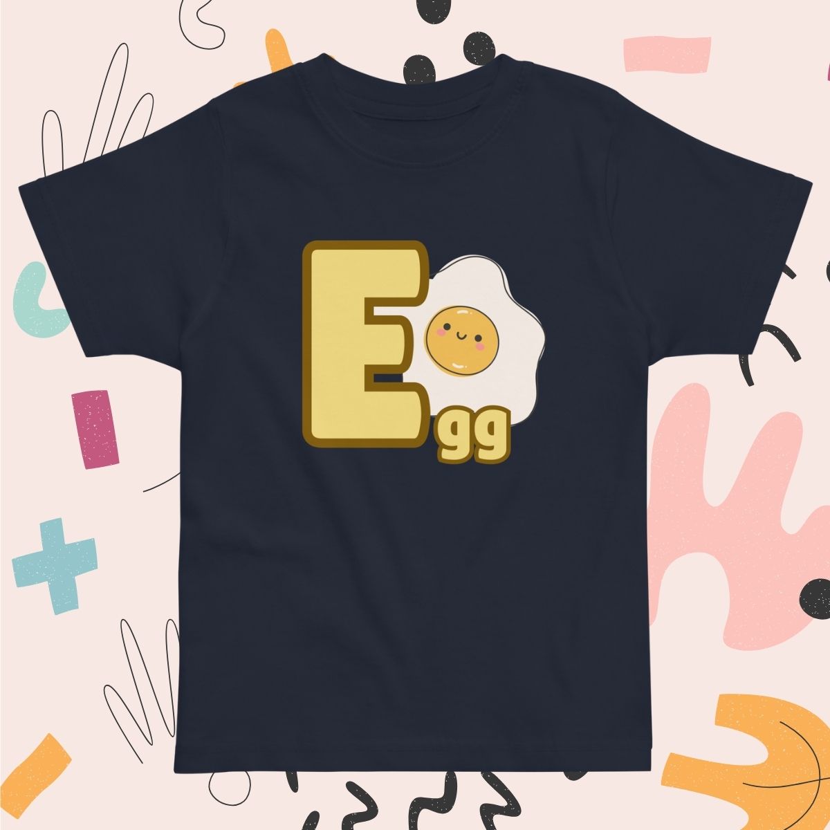 Toddler navy blue shirt designed with Egg image and text on playful pink background