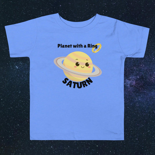 Toddler blue t-shirt with bold 'Saturn' text, Saturn graphic, and 'Planet with a Ring' subtext on a space-themed background