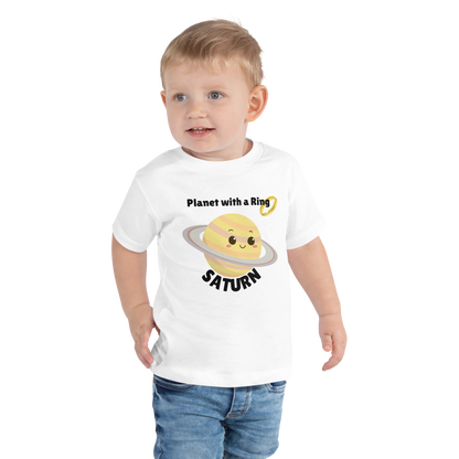 Child wearing a white t-shirt with bold 'Saturn' text, Saturn graphic, and 'Planet with a Ring' subtext on a transparent background